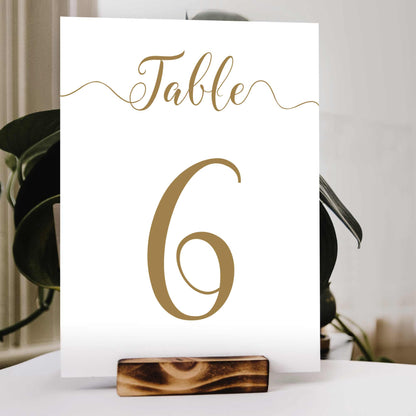 printed gold wedding table number in a wooden stand