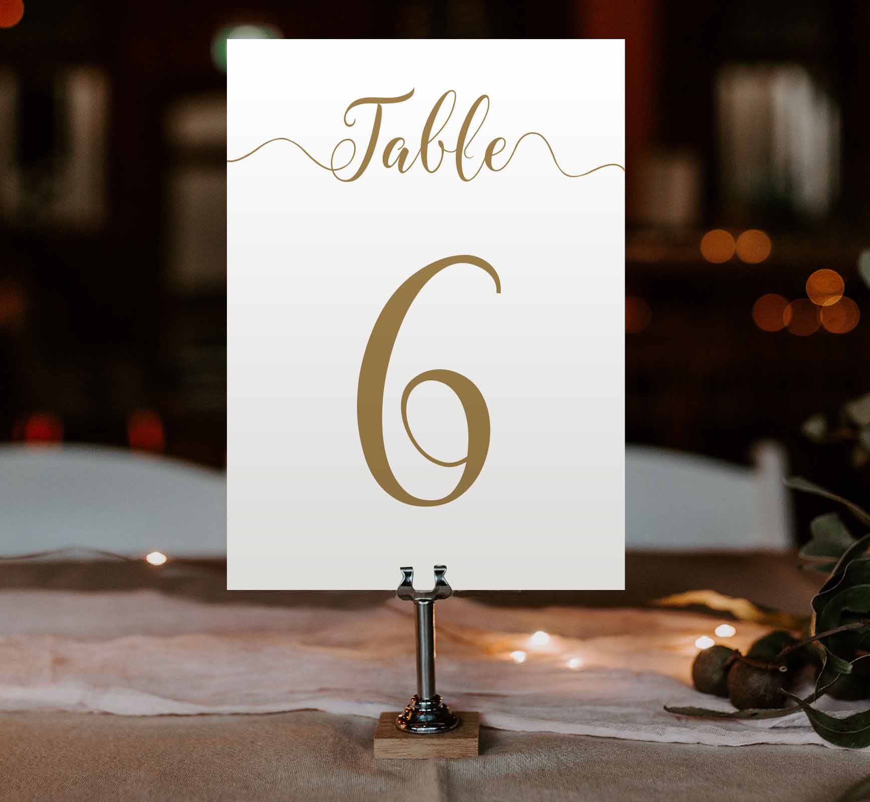 gold table number at an evening wedding reception