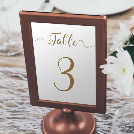 gold table number in frame on a wedding table