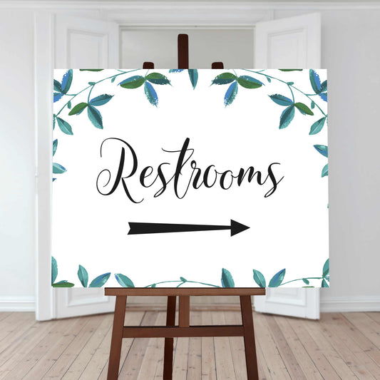 restrooms directions sign with right arrow and greenery border