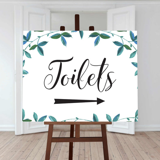printed toilet directions sign with right arrow and greenery border