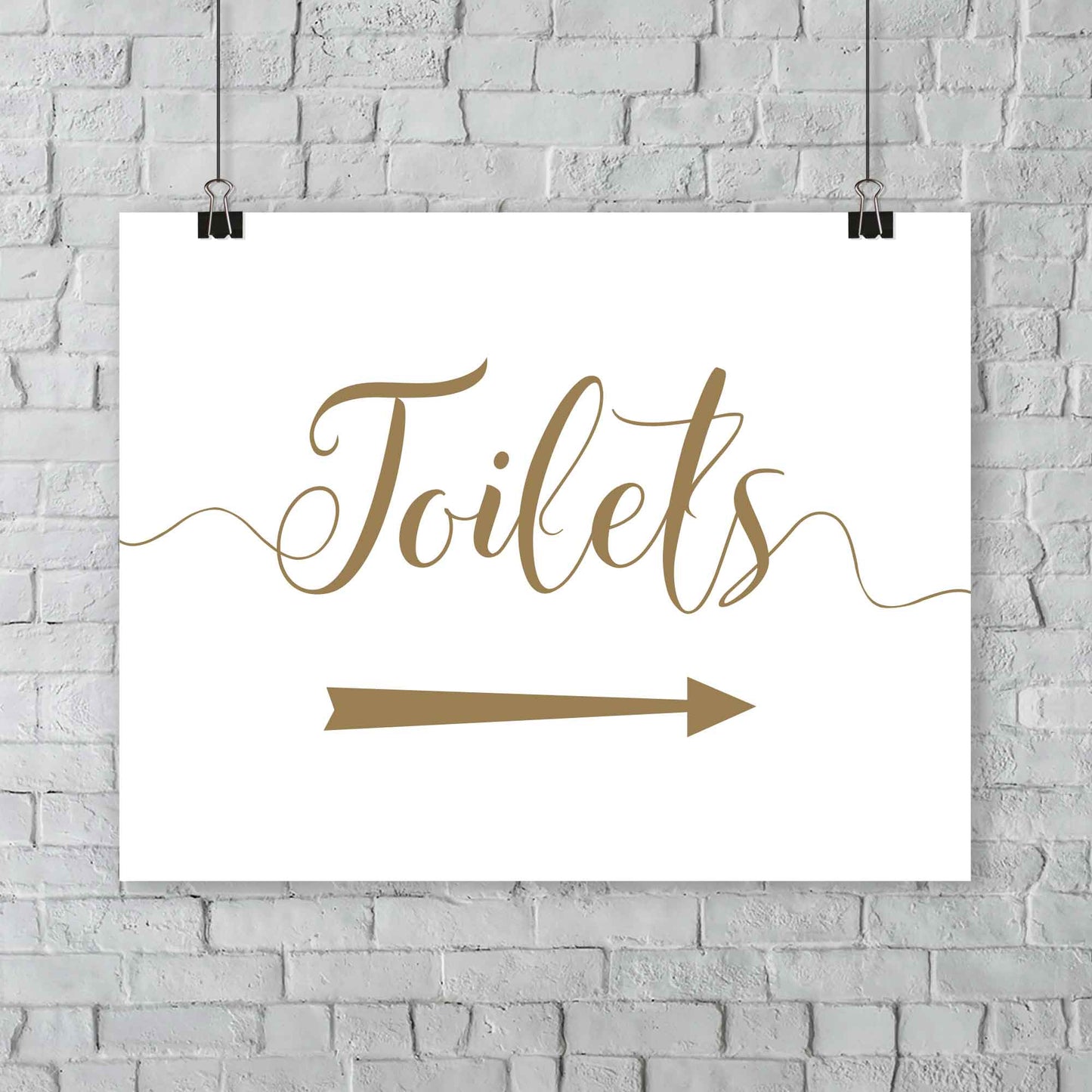 gold toilets arrow sign at outdoor wedding