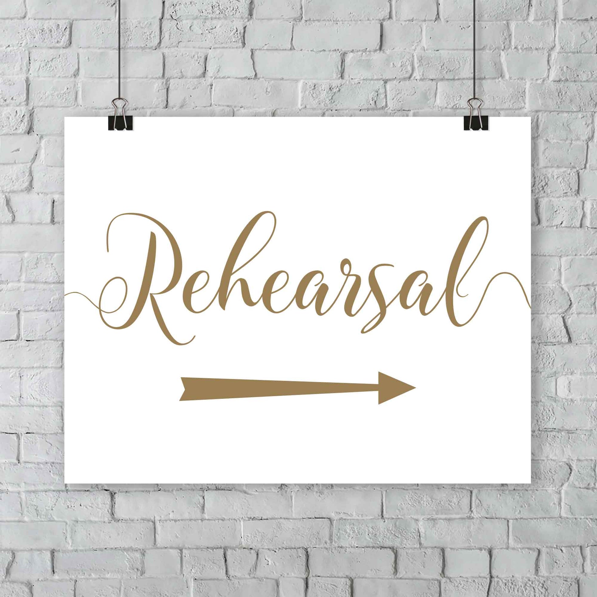 gold rehearsal sign with directional arrows