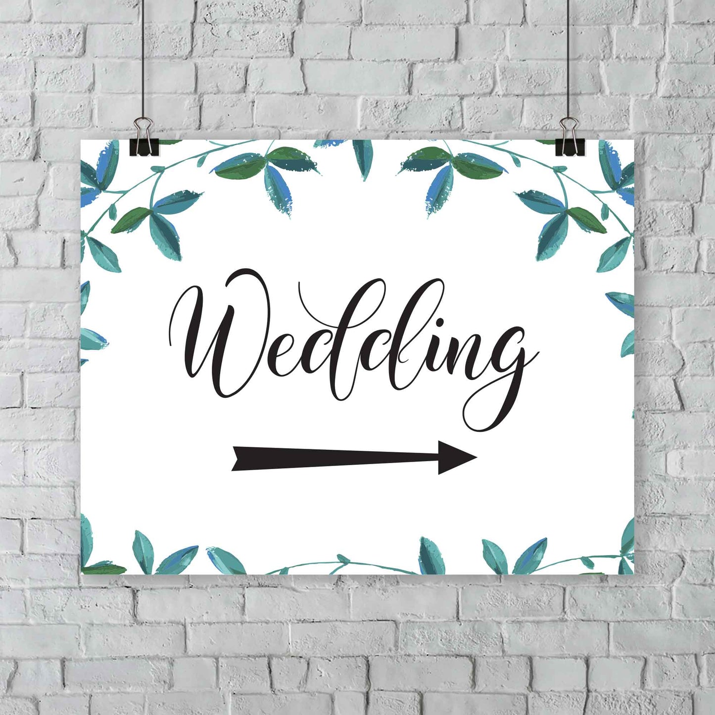 A2 green foliage wedding arrow sign hanging from a wall