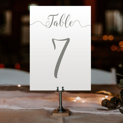 laurel green table number on a wedding table at an evening reception