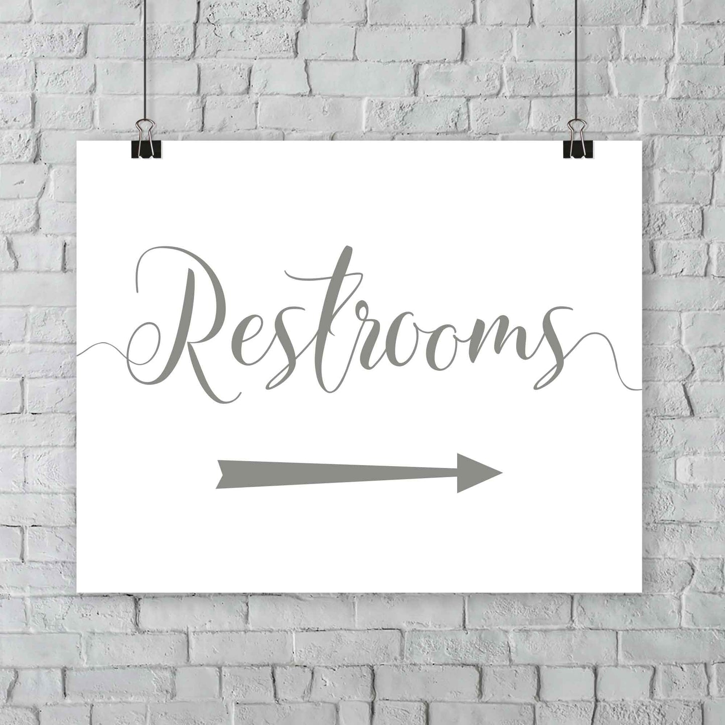 laurel green wedding restrooms arrow signage hanging from a wall