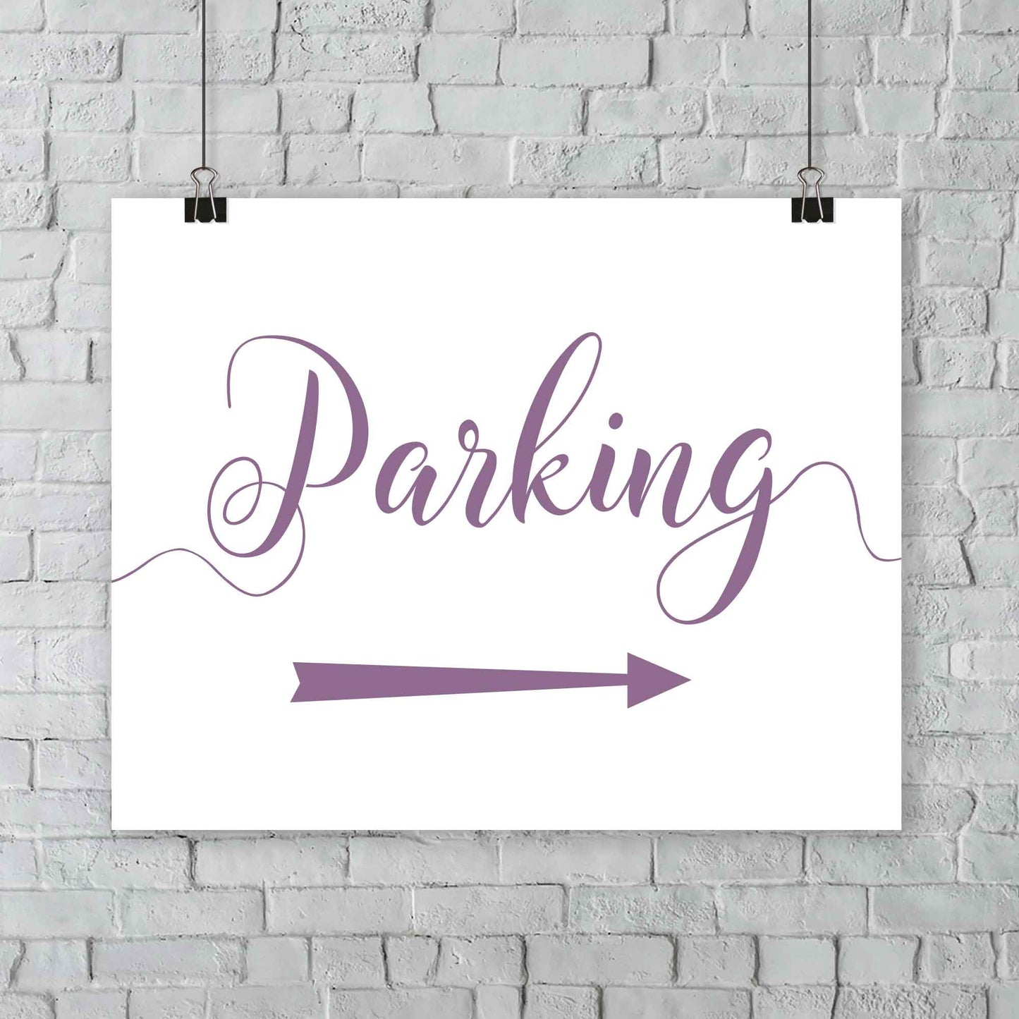 lavender purple parking lot arrow sign hanging from a wall