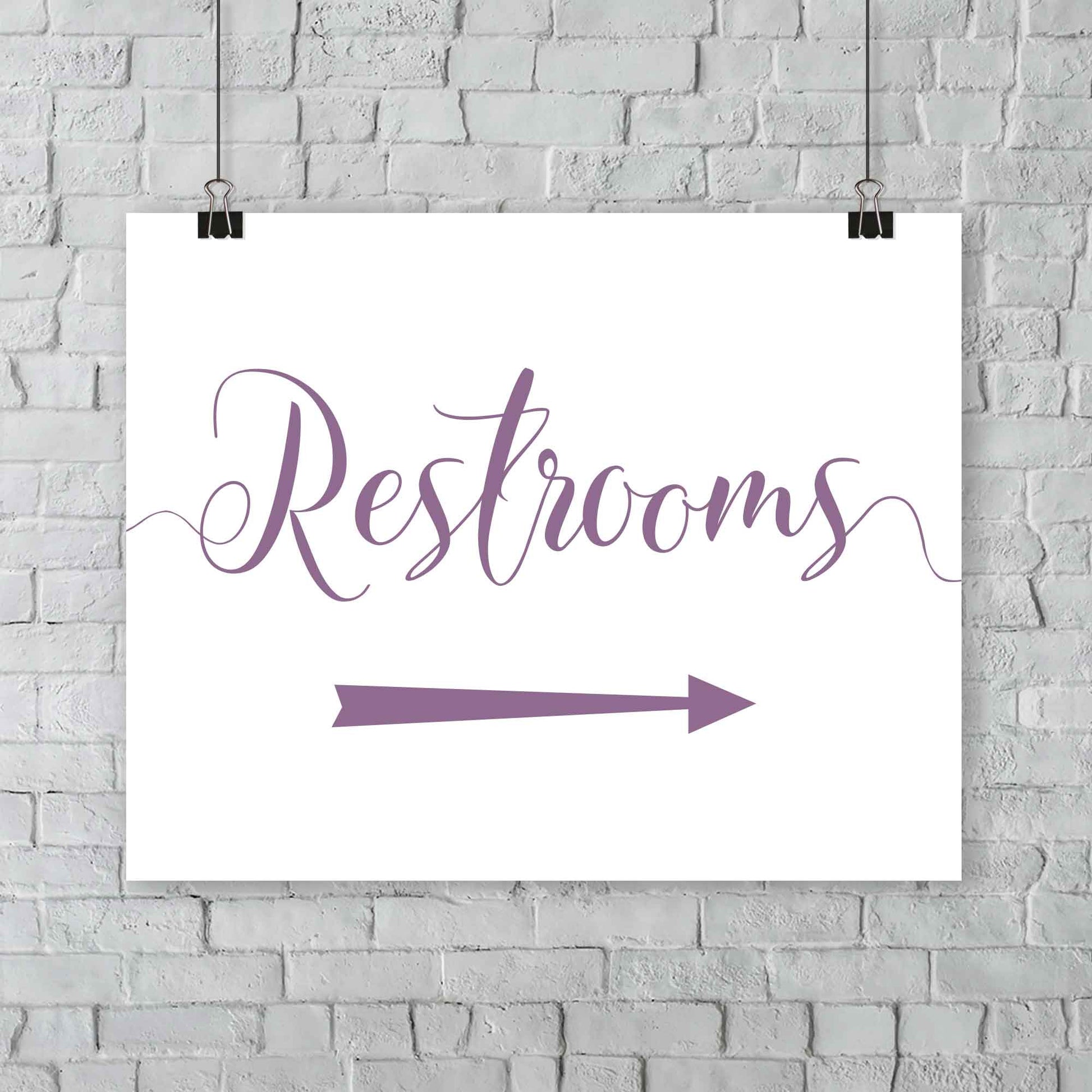 lavender purple wedding restrooms arrow signage hanging from a wall