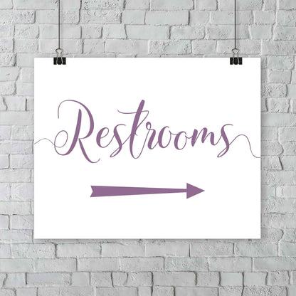 lavender purple wedding restrooms arrow signage hanging from a wall