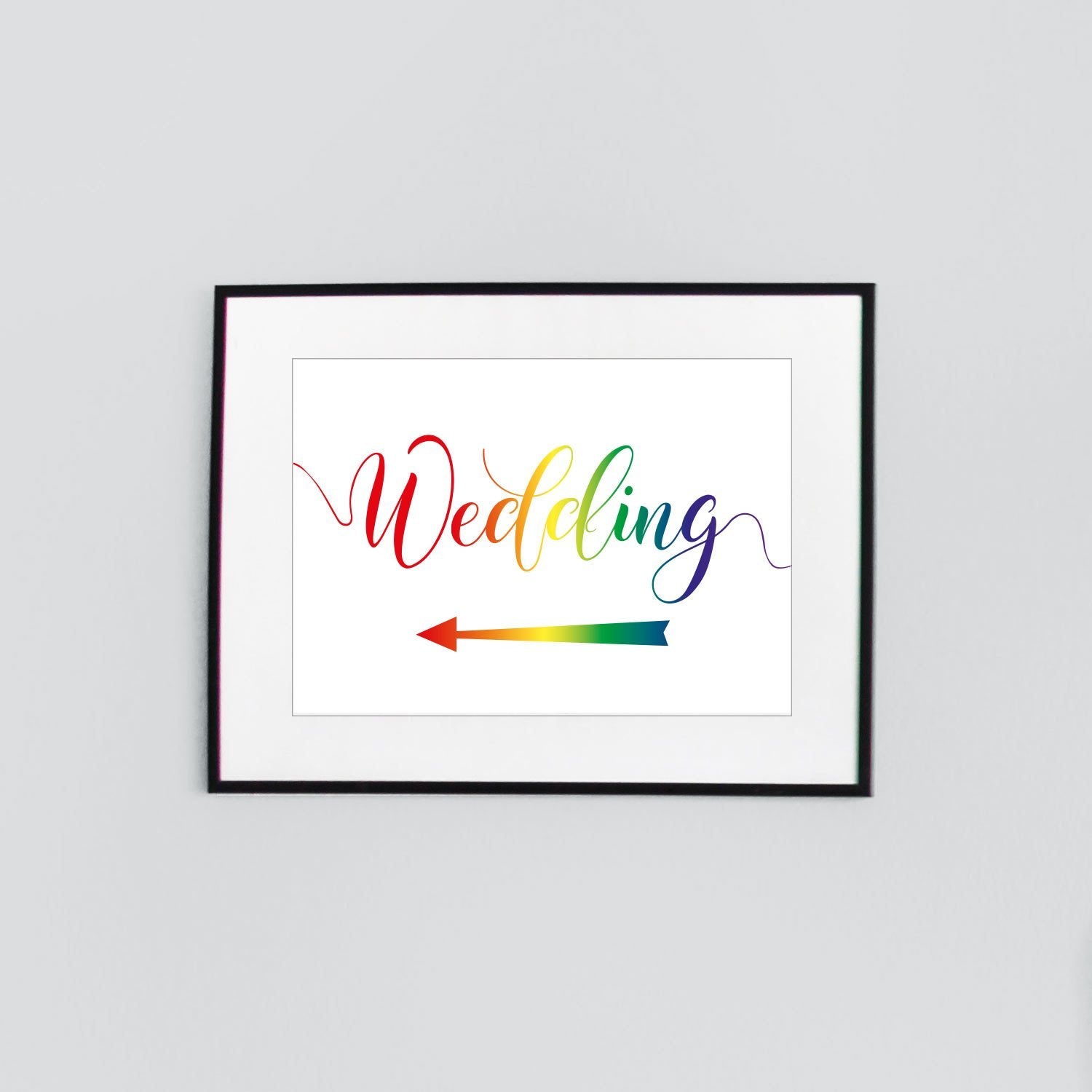 rainbow wedding sign with a directional arrow pointing left