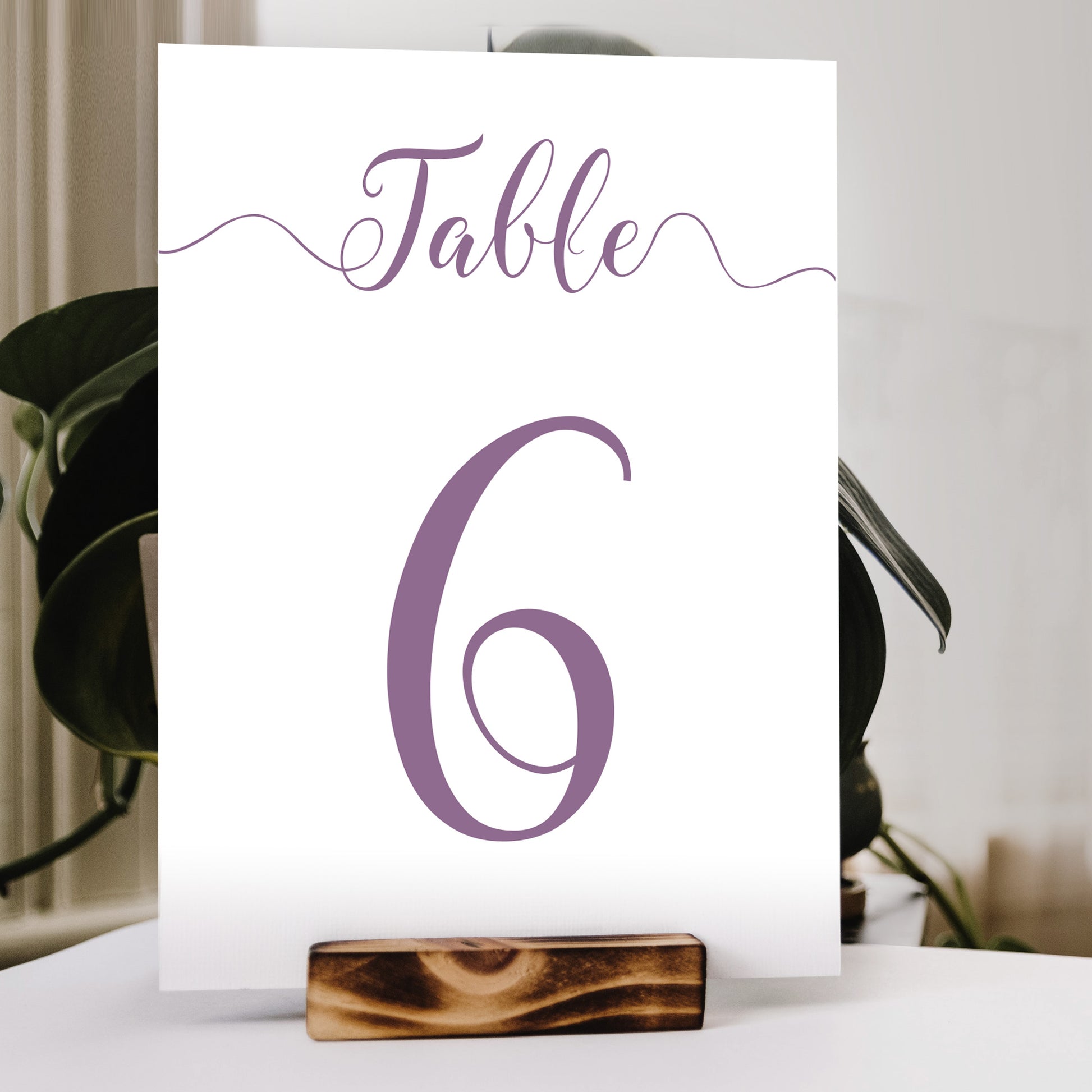 lilac purple table number print in a wooden stand at a wedding