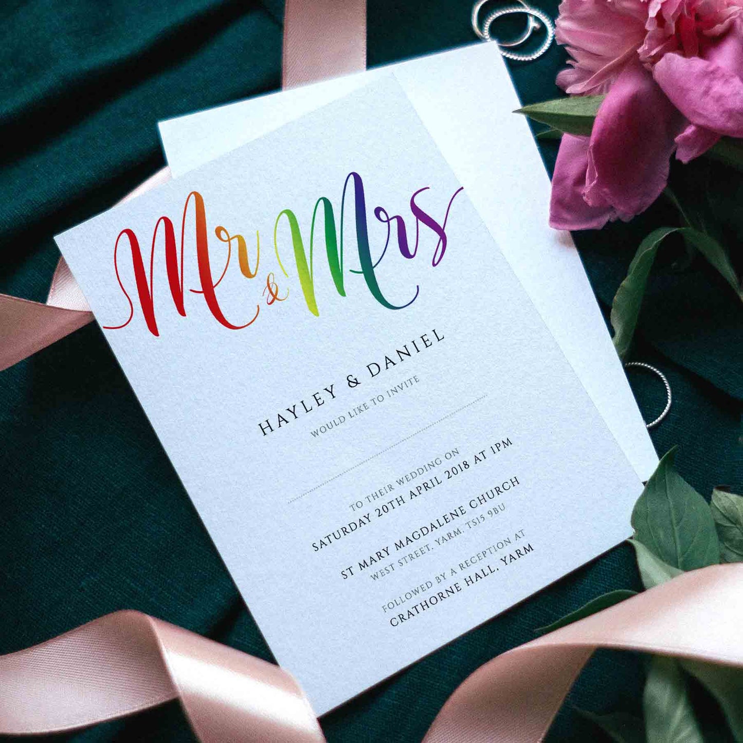 rainbow wedding invites with ribbons, flowers and rings