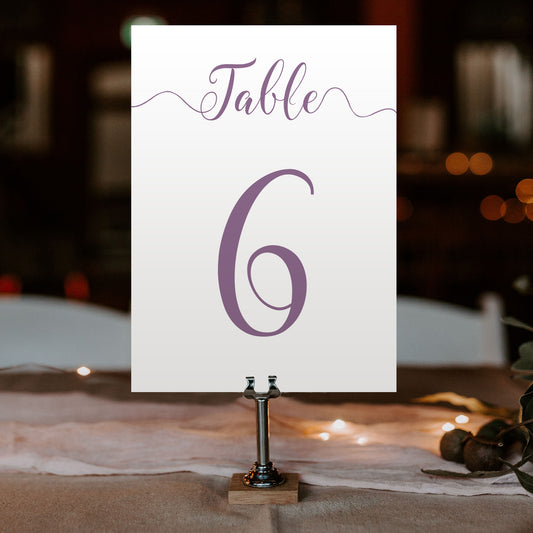 mulberry purple table number on a wedding table at an evening reception