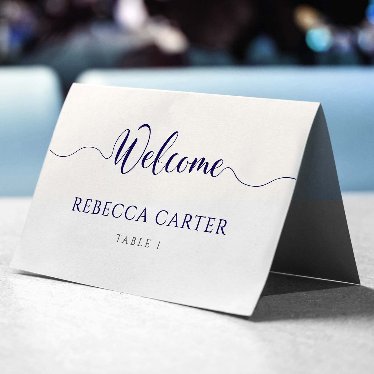 navy folded place card on a wedding table