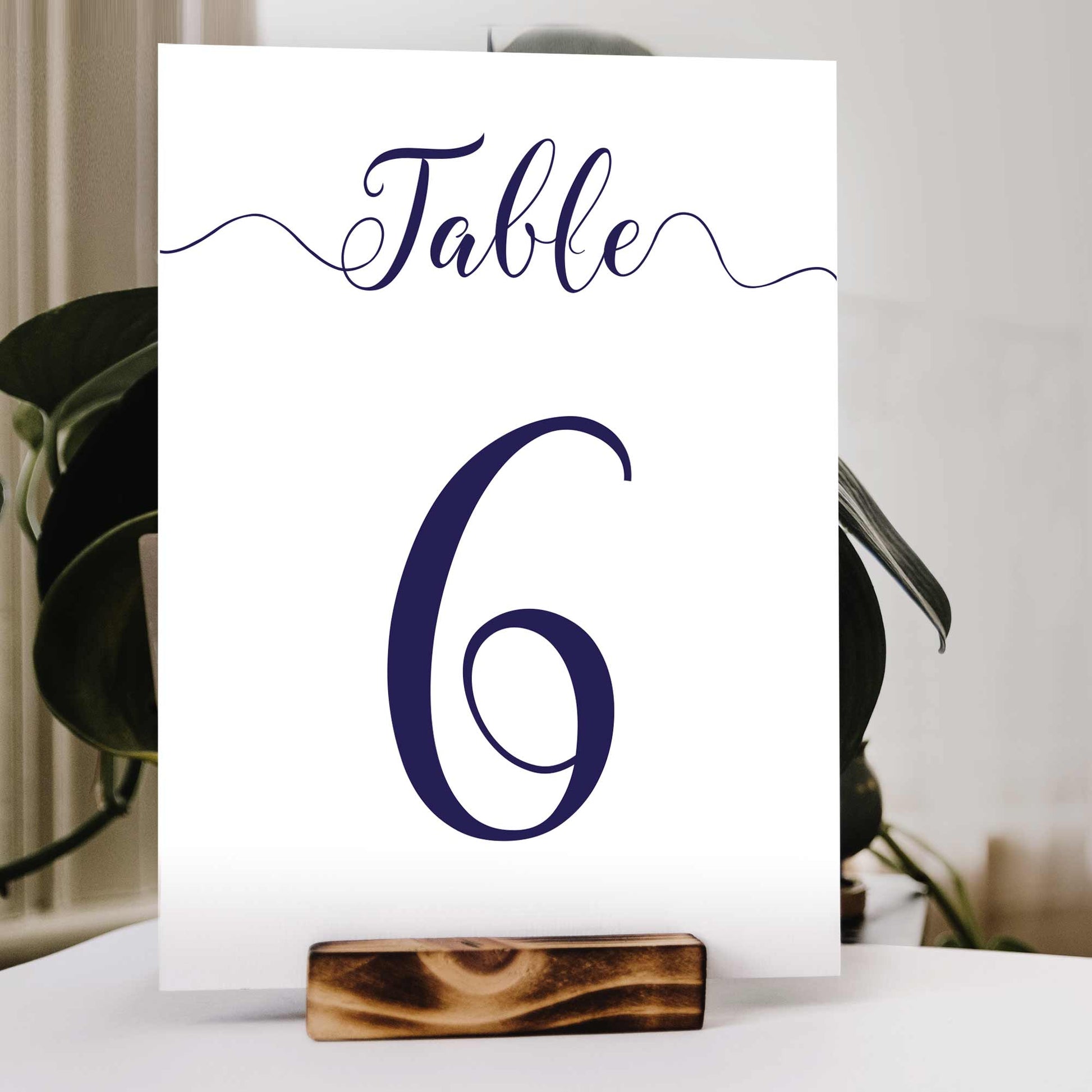 navy wedding table number in a wooden stand