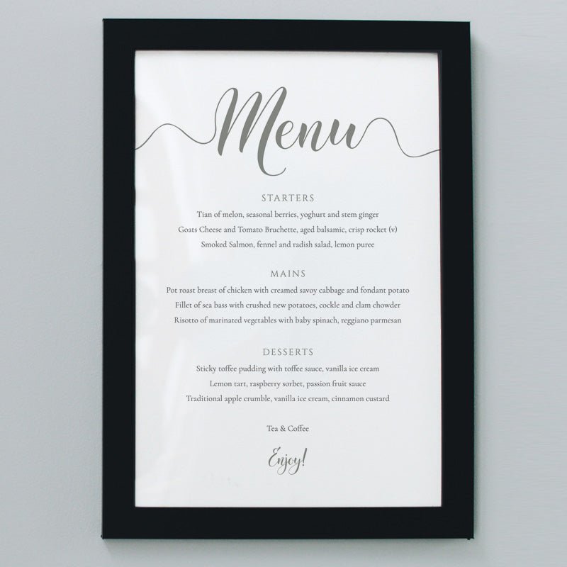 olive green wedding menu in a frame on the wall