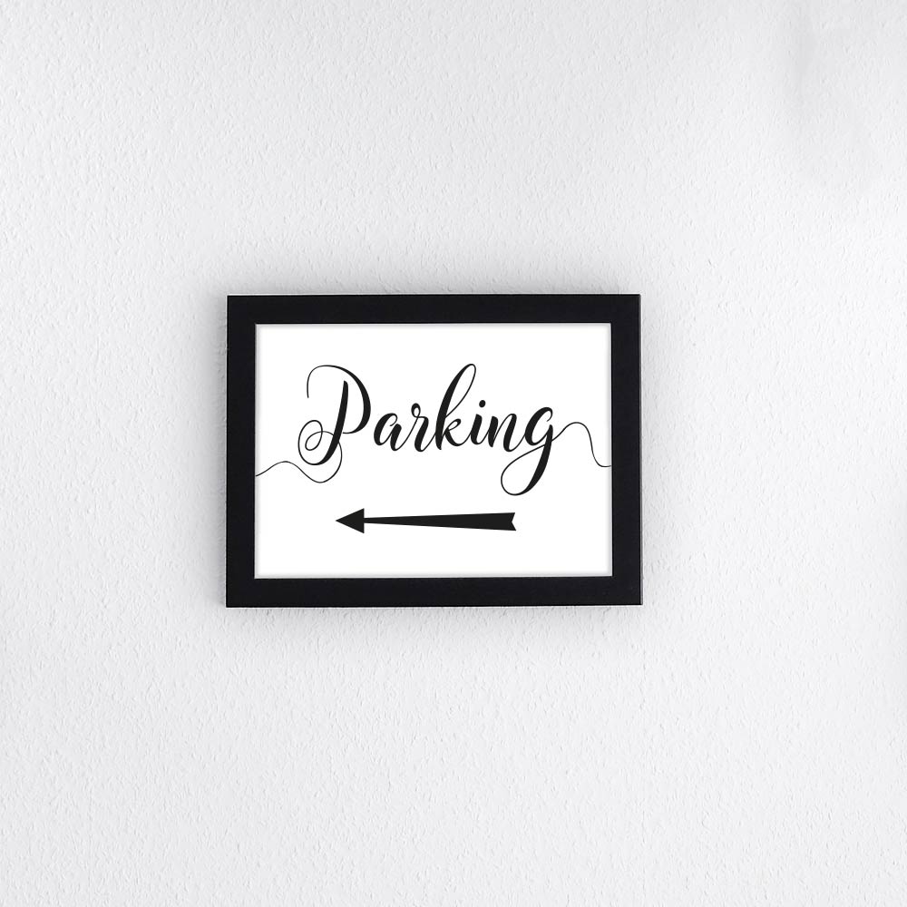 black parking arrow sign pointing to the car park