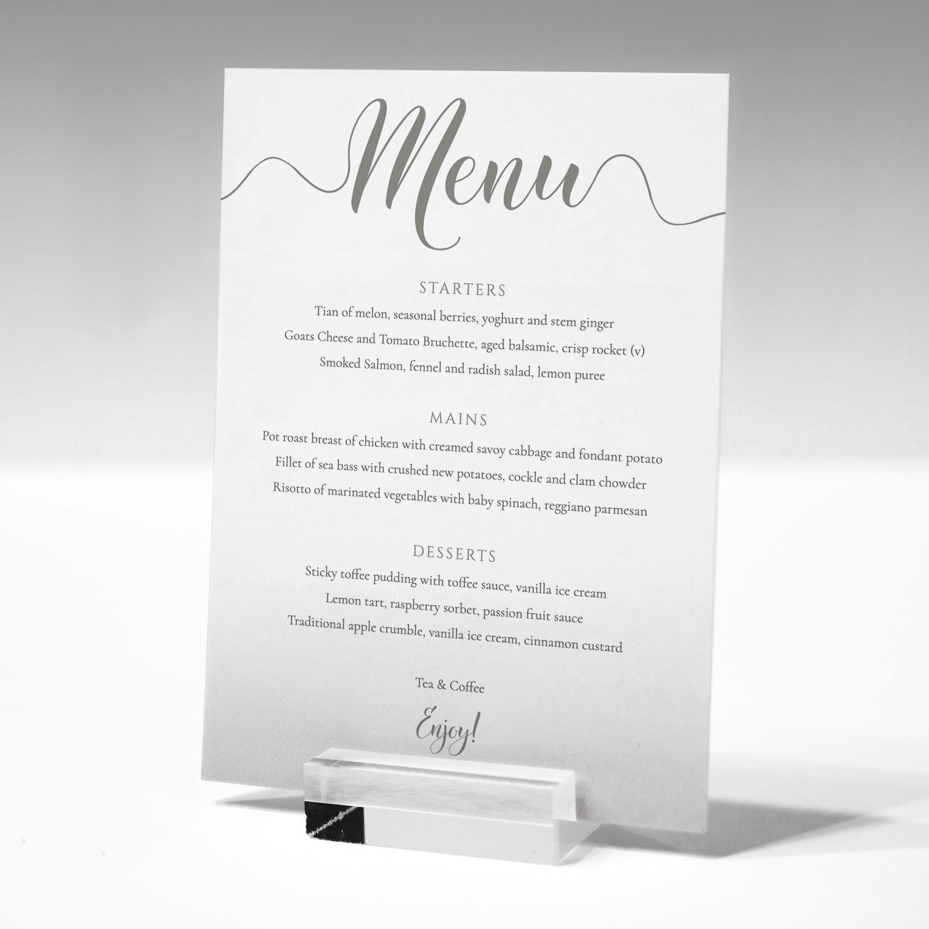 pastel green wedding menu card in a glass stand
