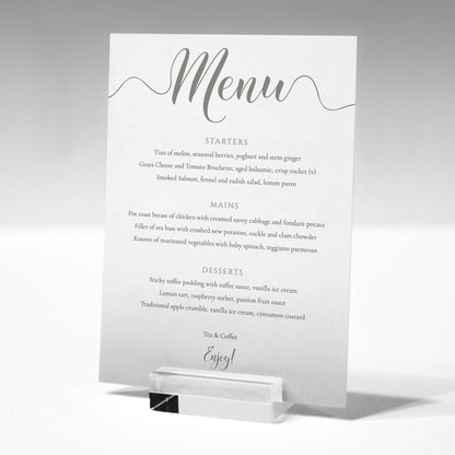 pastel green wedding menu card in a glass stand
