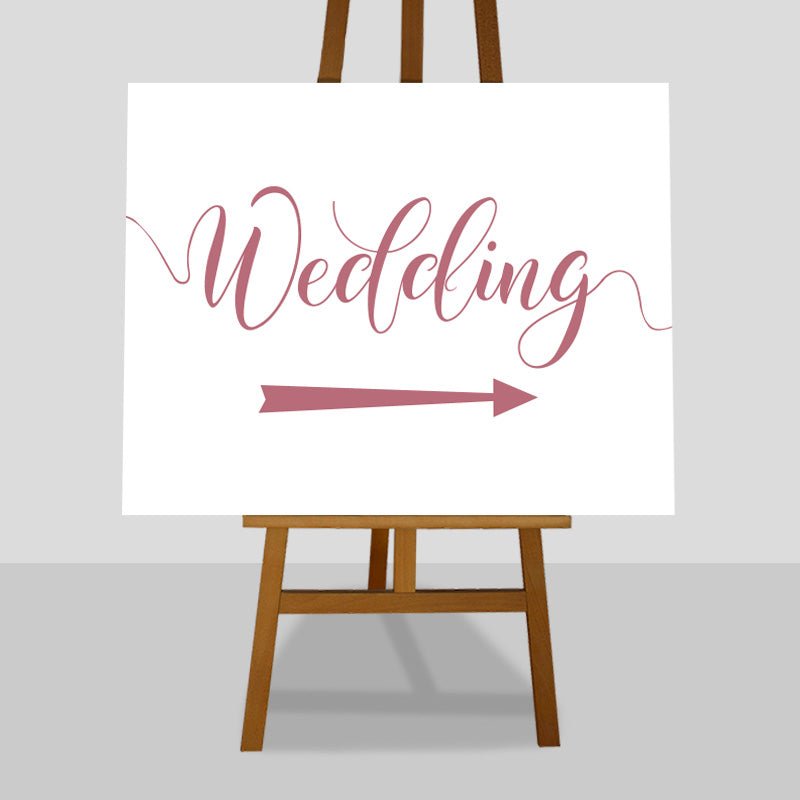 pastel pink wedding arrow sign on easel