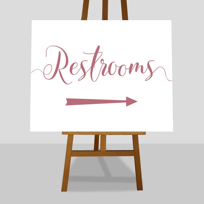 pastel pink wedding restrooms arrow sign on an easel