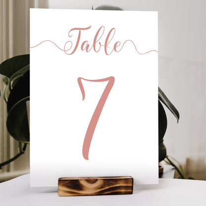 peach table number print in a wooden stand at a wedding