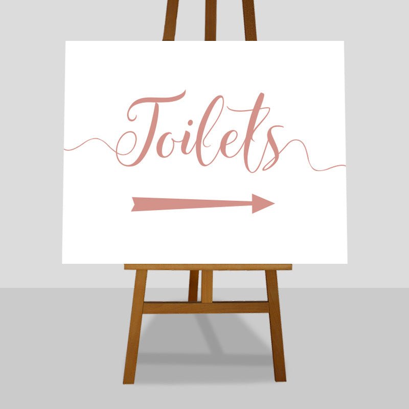 peach wedding toilets arrow sign on an easel
