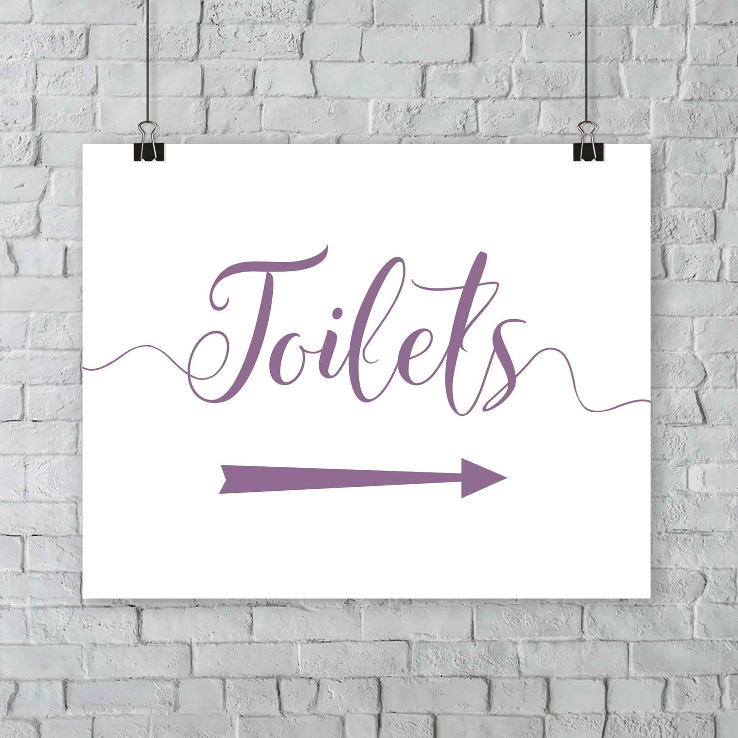 printed amethyst purple wedding toilets arrow signage on a wall