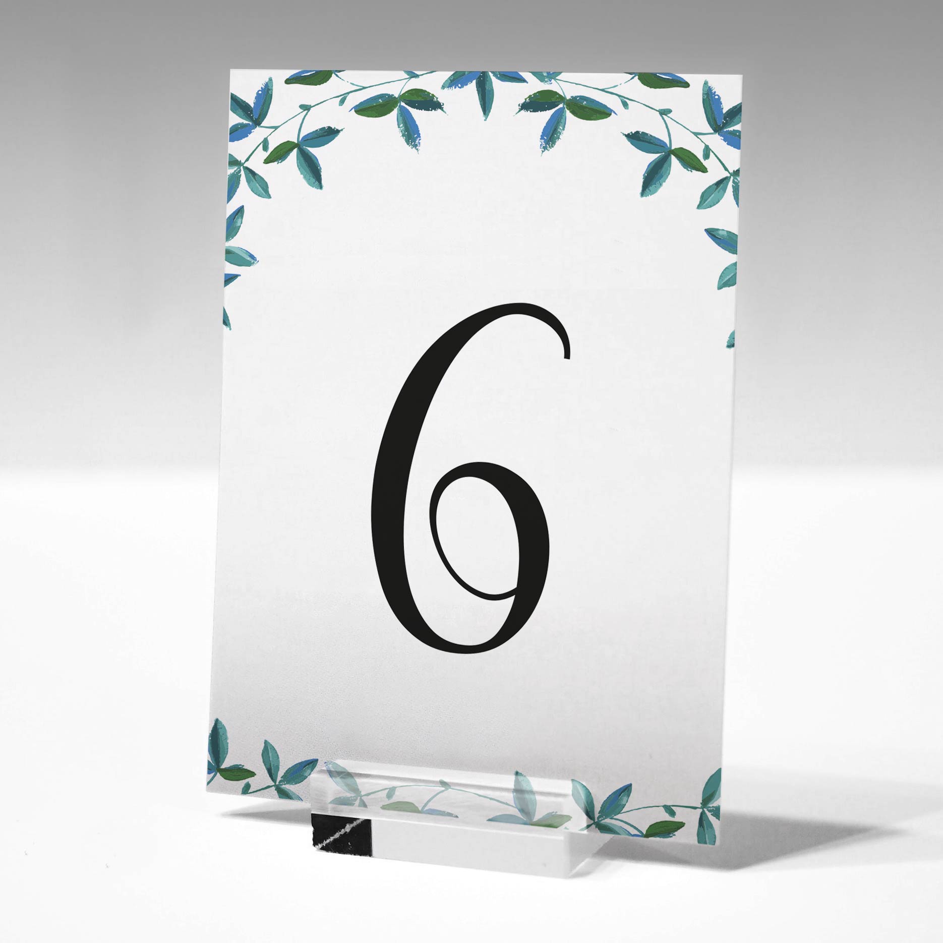 printed green leaves table number in a glass stand