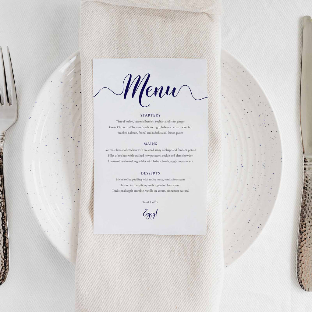 navy dinner menu on a wedding table place setting