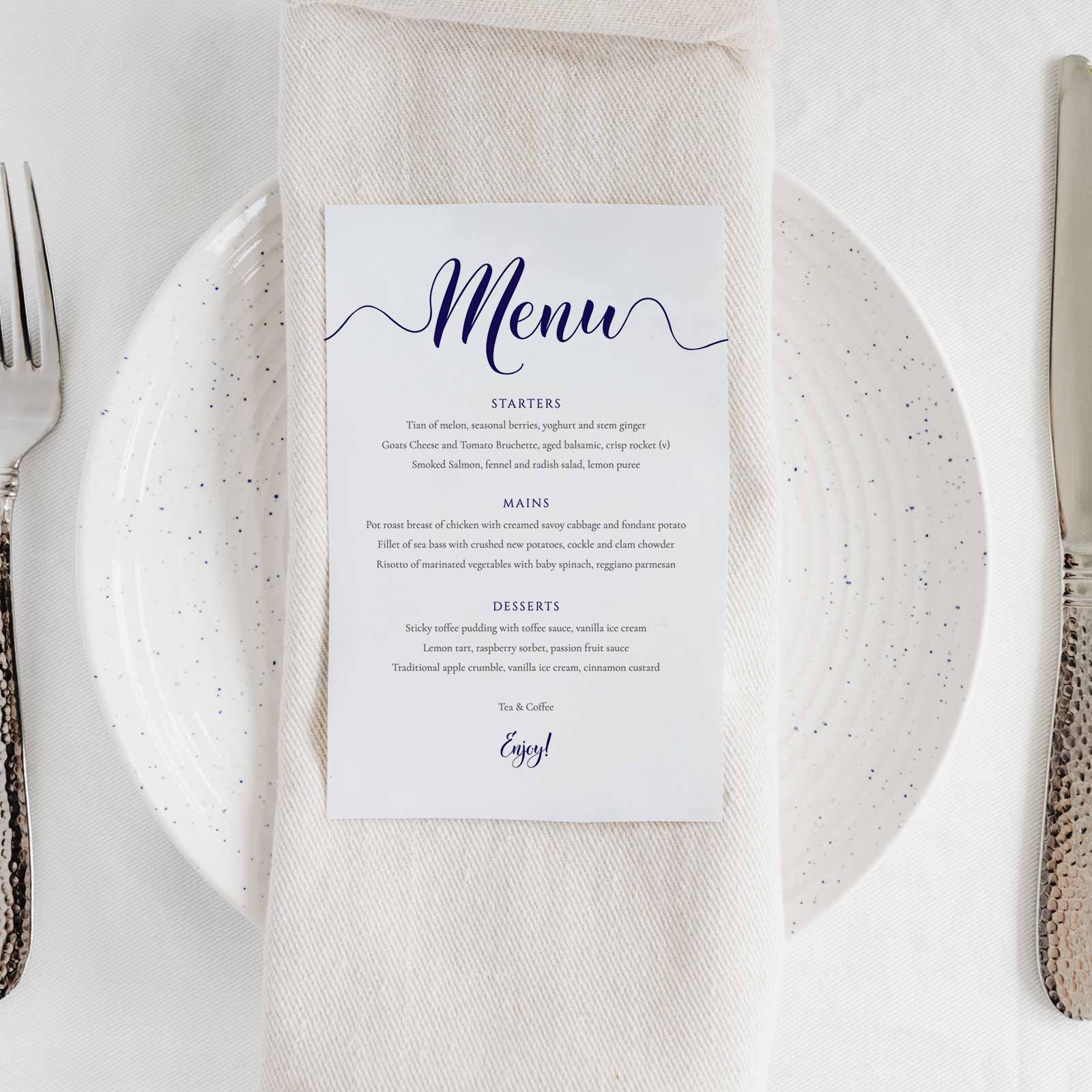 navy dinner menu on a wedding table place setting