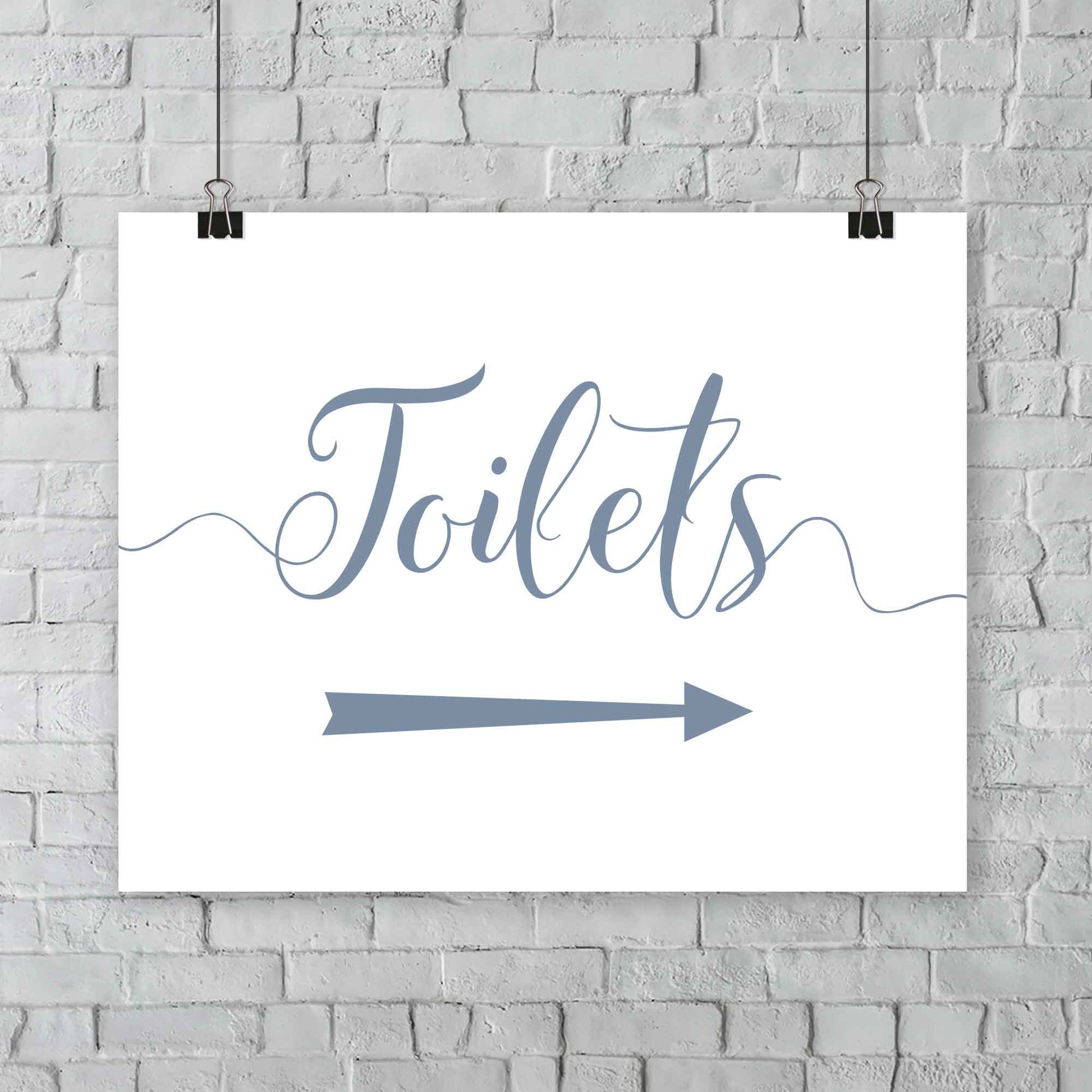 printed misty blue wedding toilets arrow signage on a wall