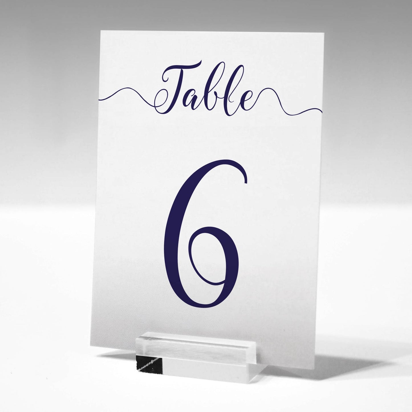 navy table number in a glass stand