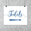 printed sapphire blue wedding toilets arrow signage on a wall