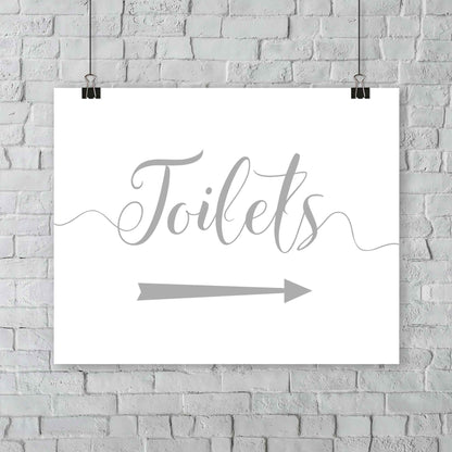 printed silver wedding toilets arrow signage on a wall