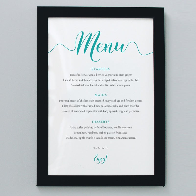 printed teal wedding menu in a black frame on the wall