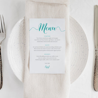 printed turquoise wedding menu card on a dinner plate