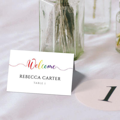pride rainbow place card and table number on a wedding table