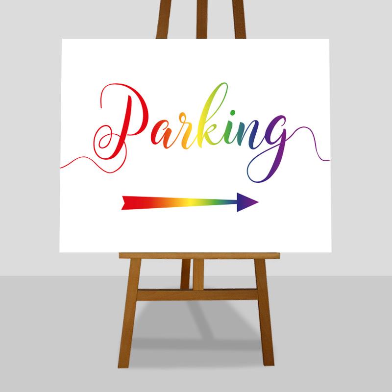 Printed car park directions sign in rainbow colours