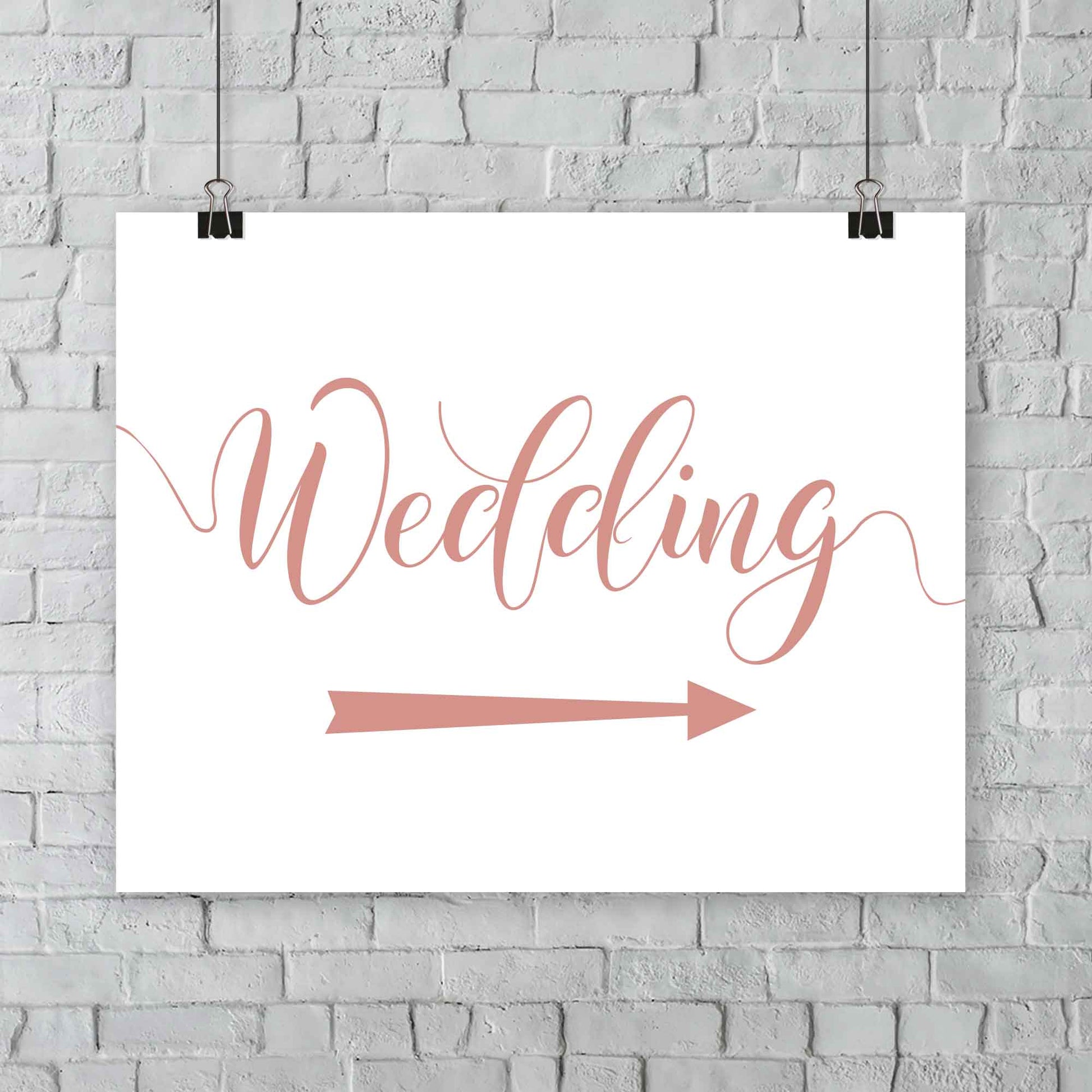 rose gold wedding arrow sign print hanging from a wall