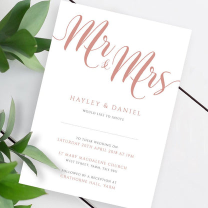 rose gold wedding invitation template on a white table