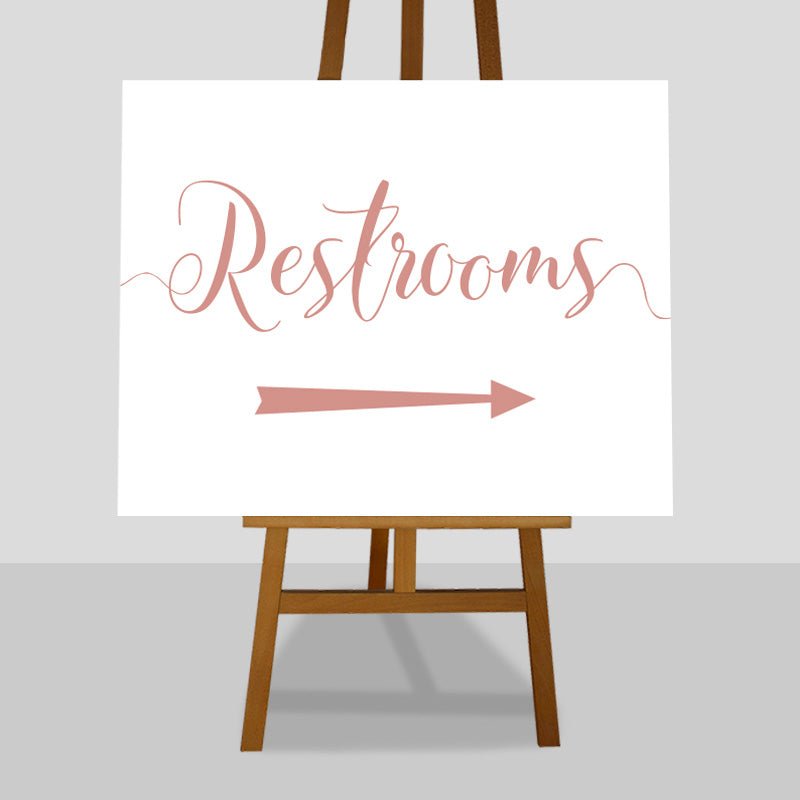 rose gold wedding restrooms arrow sign on an easel