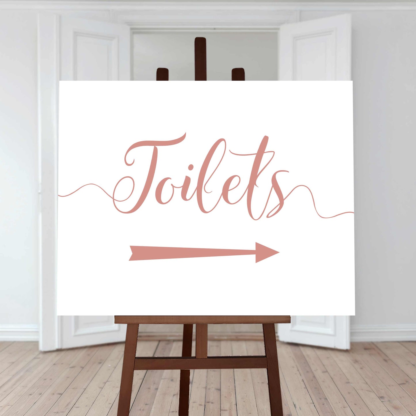 rose gold wedding toilet directions sign with an arrow pointing right