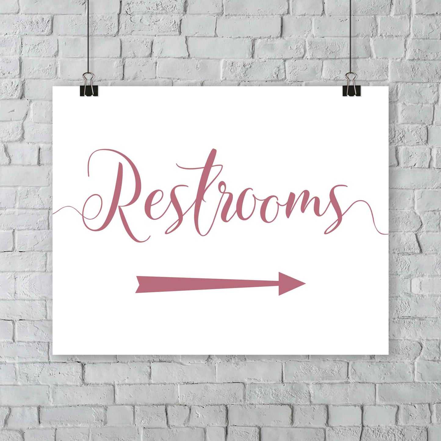 rouge pink wedding restrooms arrow signage hanging from a wall