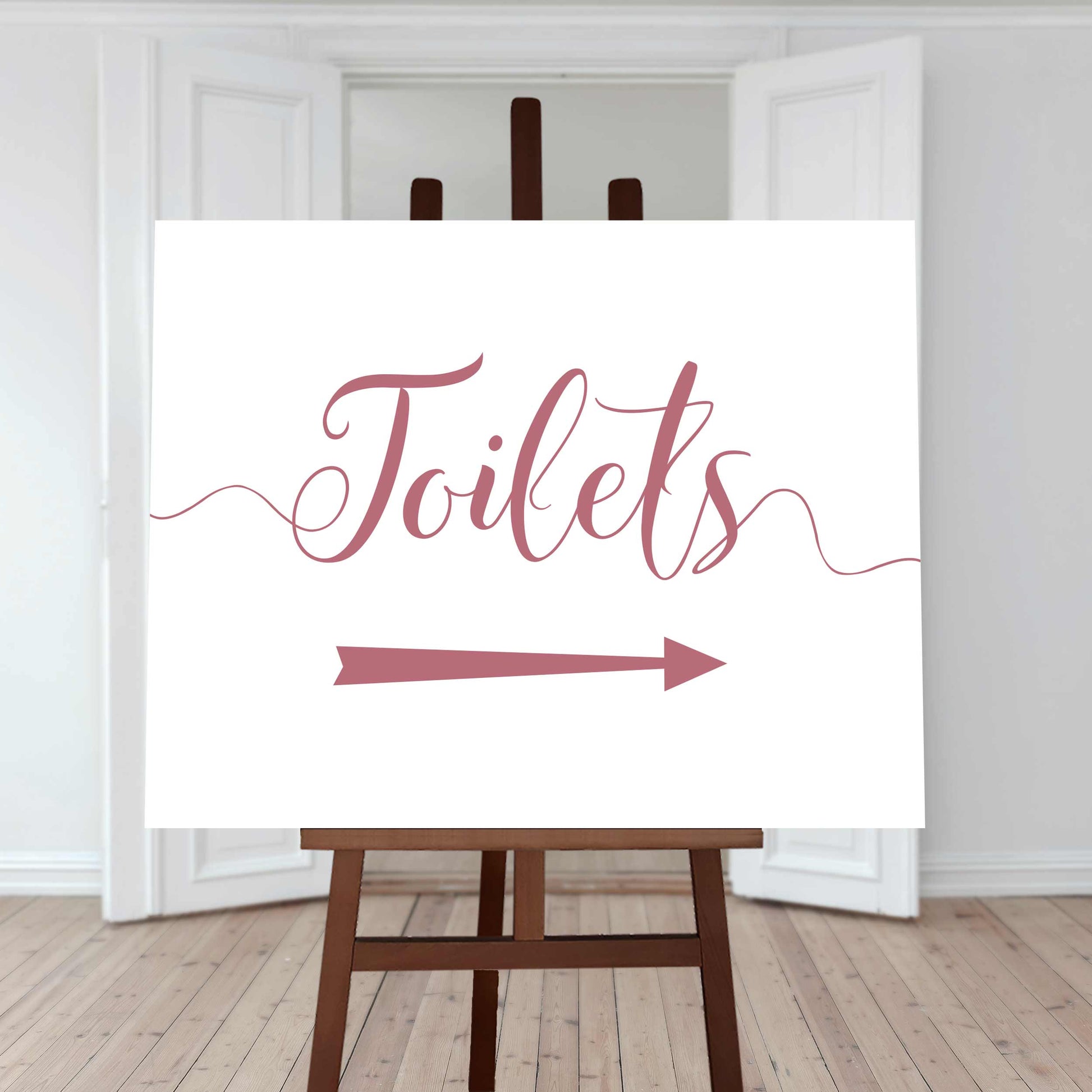 rouge pink wedding toilet directions sign with an arrow pointing right