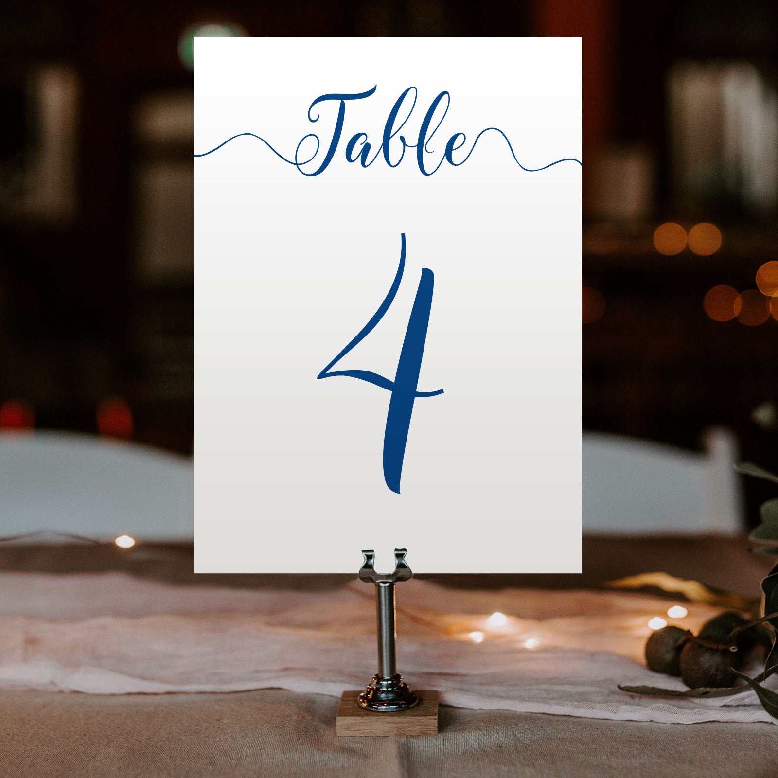 royal blue table number on a wedding table at an evening reception