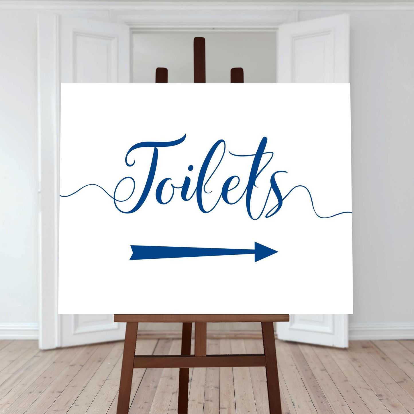 royal blue wedding toilet directions sign with an arrow pointing right
