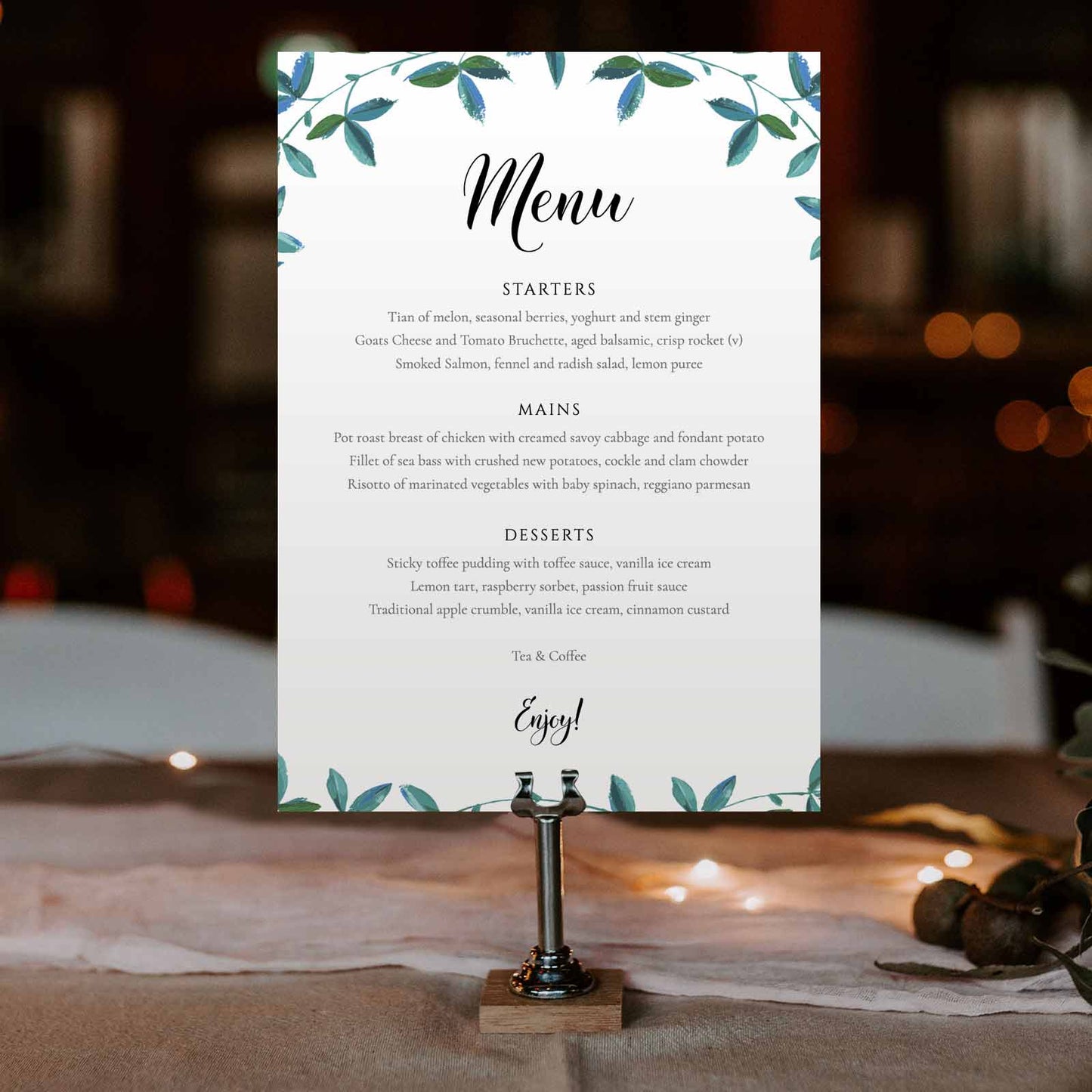 boho eucalyptus wedding menu card in a steel stand