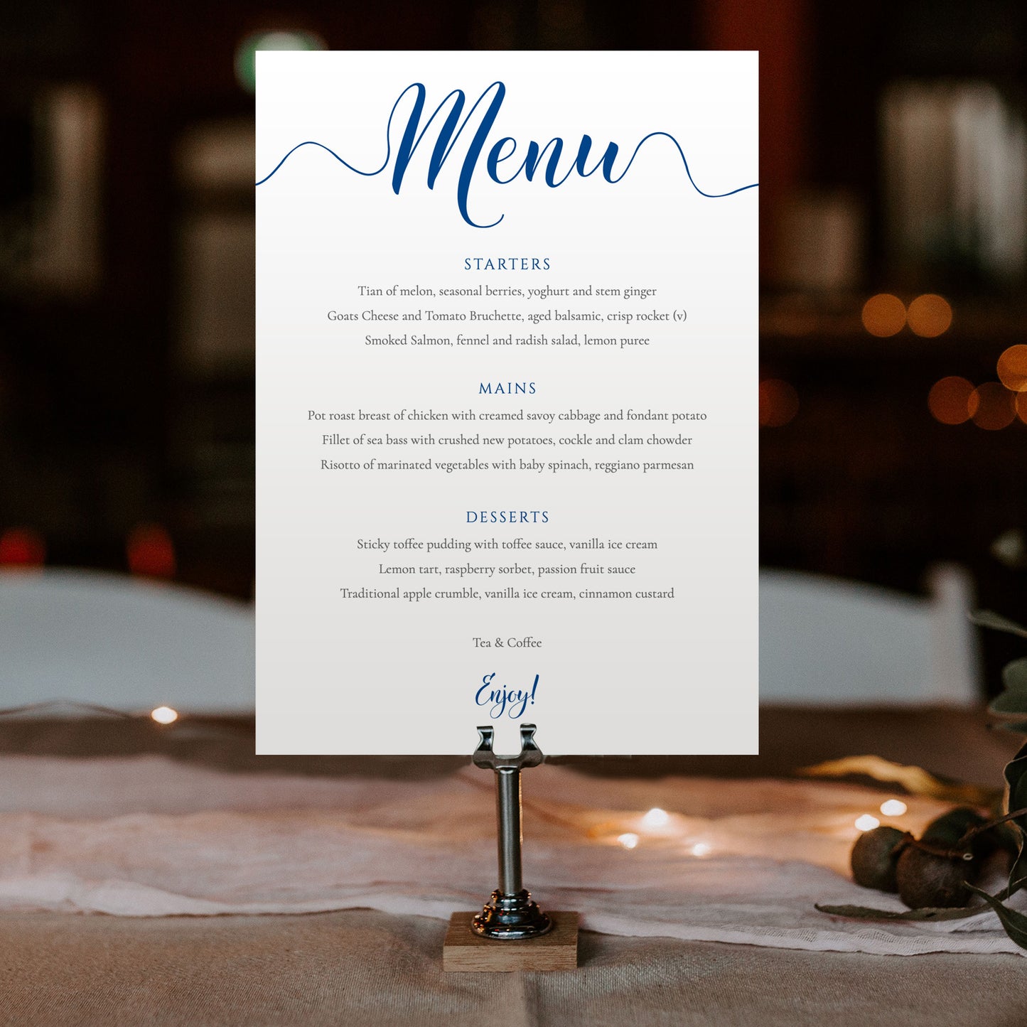 sapphire blue menu card in a metal stand at a wedding reception