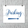 sapphire blue parking lot arrow sign hanging from a wall